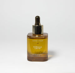 Close-up of Sand + Fog Vanilla Latte parfum oil bottle with amber glass for cozy notes.