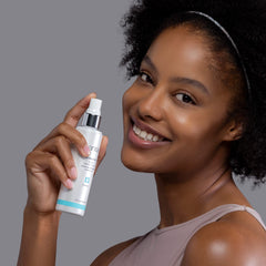 Sanitas Moisture Mist application on cheek shows light, even hydration