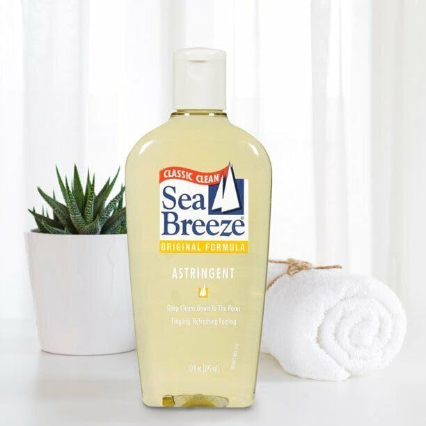 Sea Breeze Astringent Original 10oz cotton pad application depicts post-cleanse toning routine.