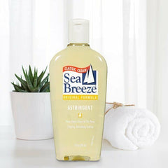 Sea Breeze Astringent Original 10oz cotton pad application depicts post-cleanse toning routine.