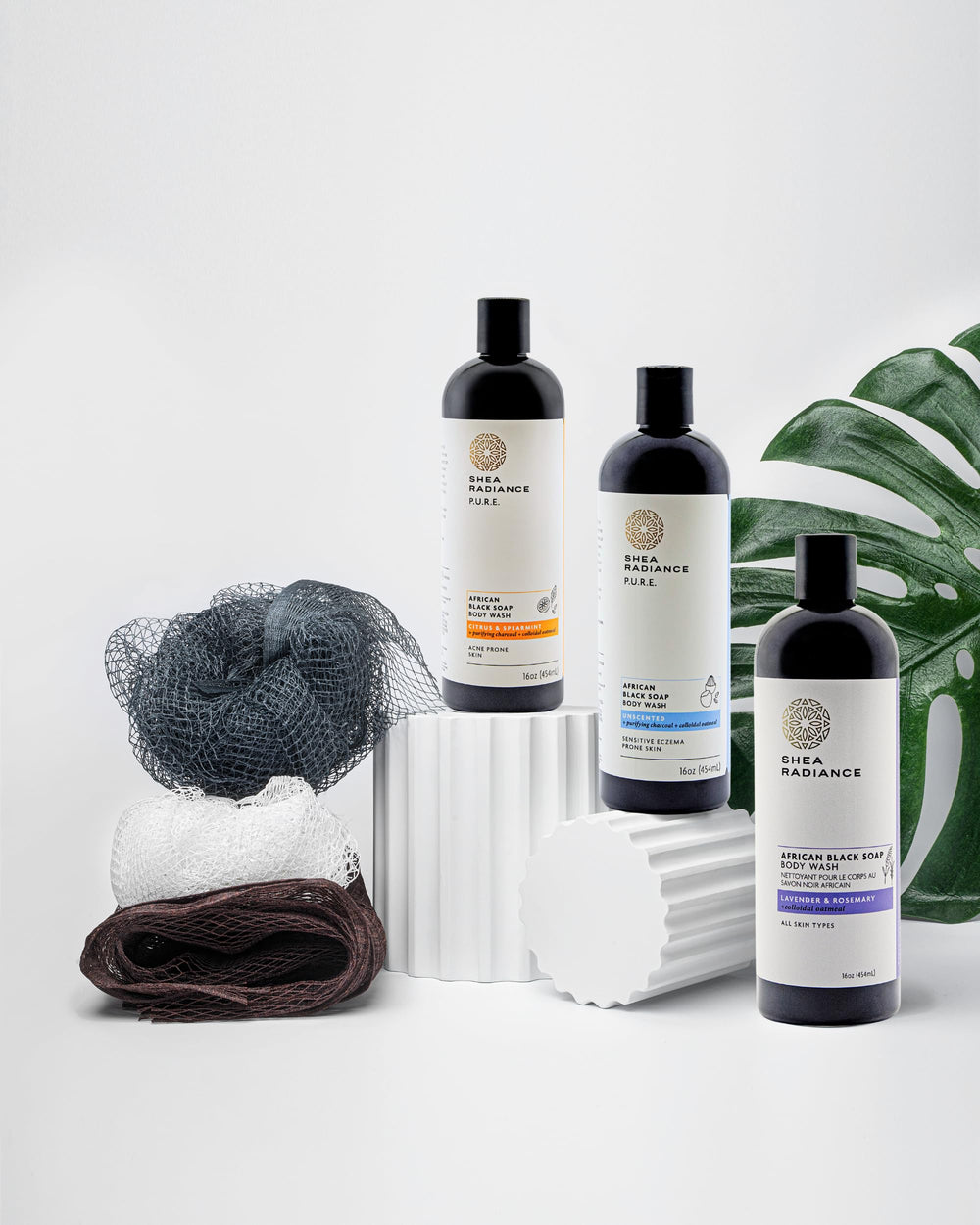 Shower routine setup featuring Shea Radiance beside a loofah