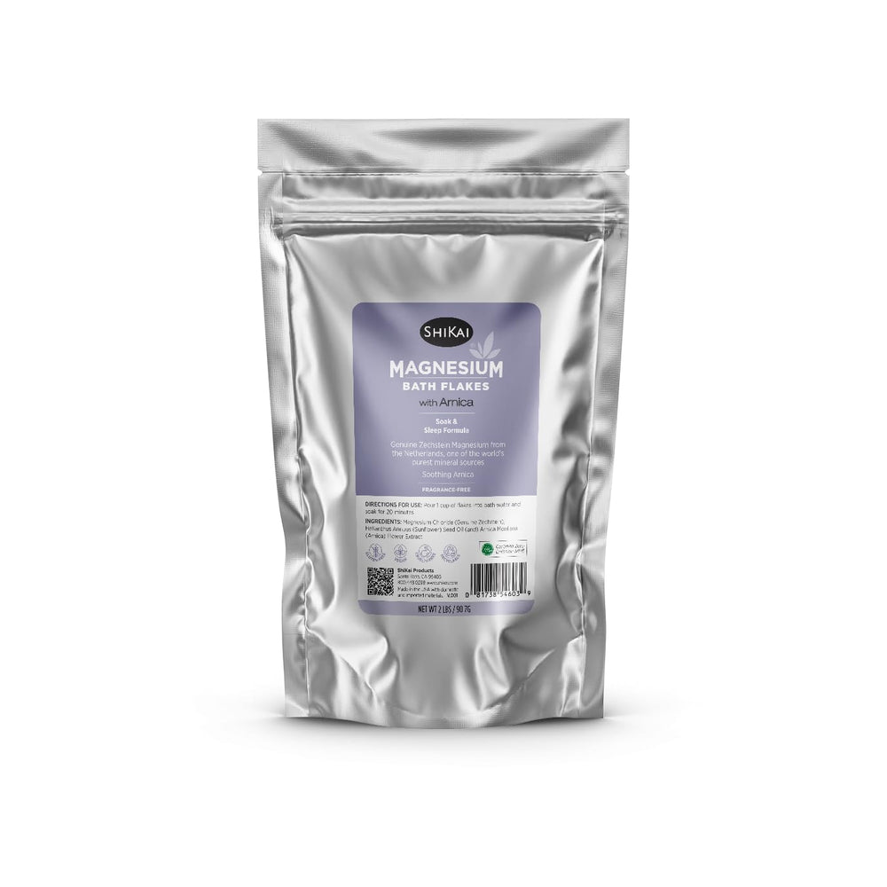 ShiKai magnesium bath flakes with arnica soaking in tub for soothing relaxation