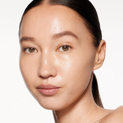 Shiseido RevitalEssence Skin Glow Foundation brush application highlights buildable coverage with seamless blending.