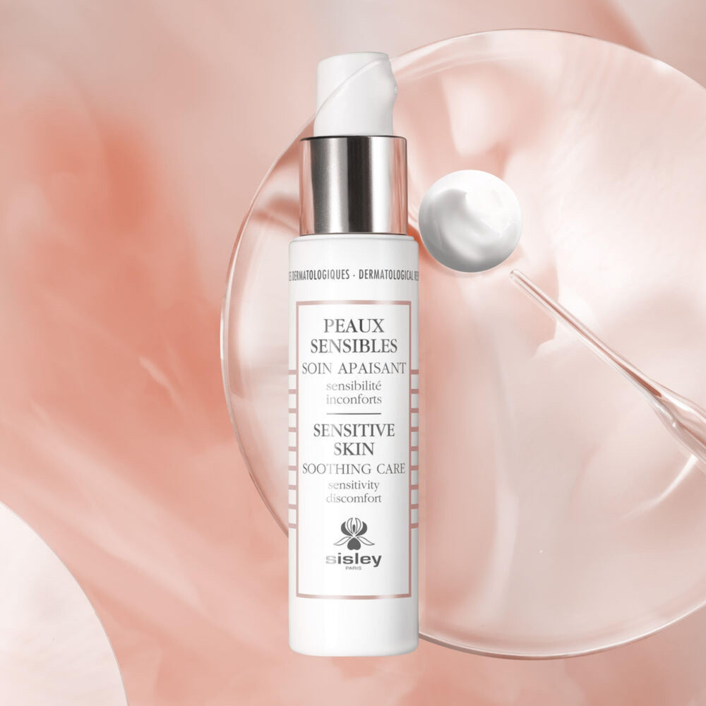 Gently massaging Sisley Paris Sensitive Skin Soothing Care into the face.
