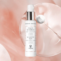 Gently massaging Sisley Paris Sensitive Skin Soothing Care into the face.