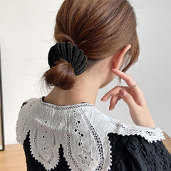 Clip worn at a party or wedding in black, showcasing versatility