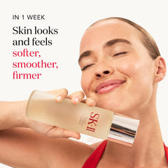 Patting SK-II Facial Treatment Essence onto the face to even texture and glow.