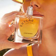 Skylar Citrus Reverie bottle with side view and wooden cap detail.