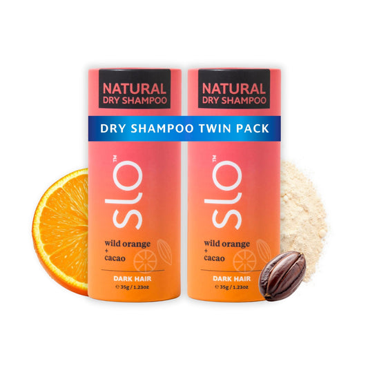 Slo dark hair dry shampoo bottle with Wild Orange and Cacao scent for refreshed roots.