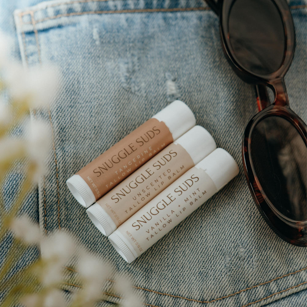 Snuggle Suds Unscented herbal lip balm for sensitive lips with fragrance-free care.