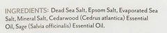 Soothing Touch Cedar Sage bath salts pouch in bath scene suggests spa-like relaxation.