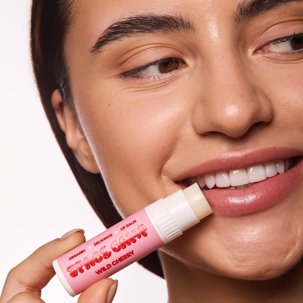 Space Camp Wellness lip balm being applied for daily moisture