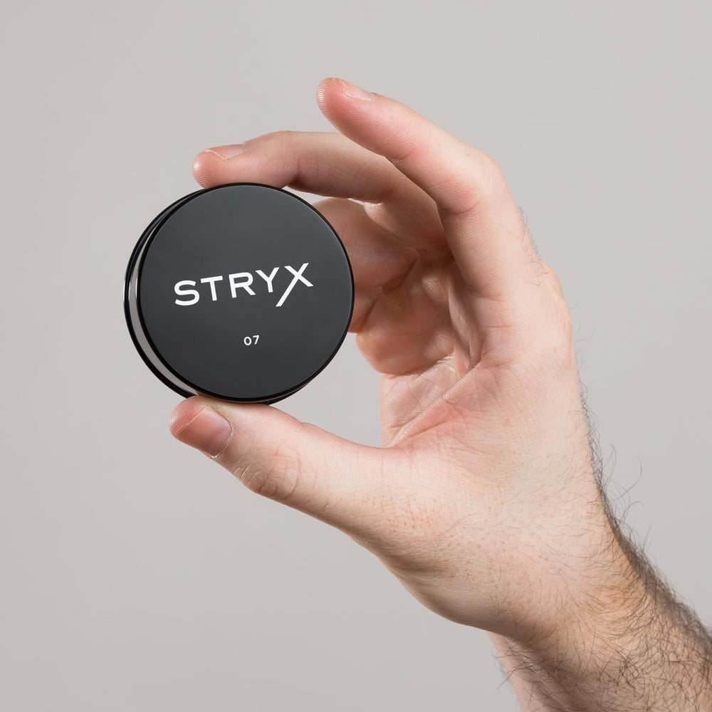 Stryx Anti-Shine Powder pocket-sized for workouts and travel.