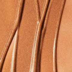 Summer Fridays Bronzing Drops on cheek creating a soft glow.