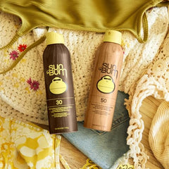 Sun Bum Original spray applied to hands for easy sun protection.
