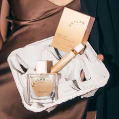 Sunlit desk scene with Vanilla Sky bottle suggests a daytime fragrance ritual.