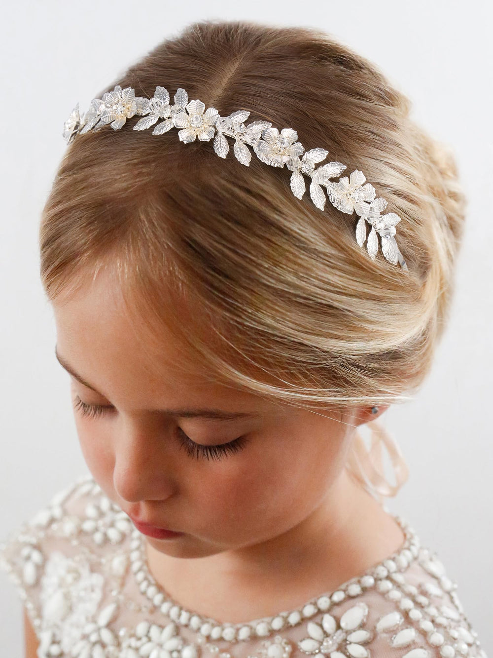 Closeup of ivory pearl detail on SWEETV flower girl headpiece.