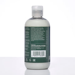 Lavender sprigs beside Tea Tree Lavender Mint conditioner for calming fragrance.