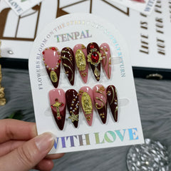 TENPAL long stiletto nails in nude pink wine with a cross charm for elegant wedding looks