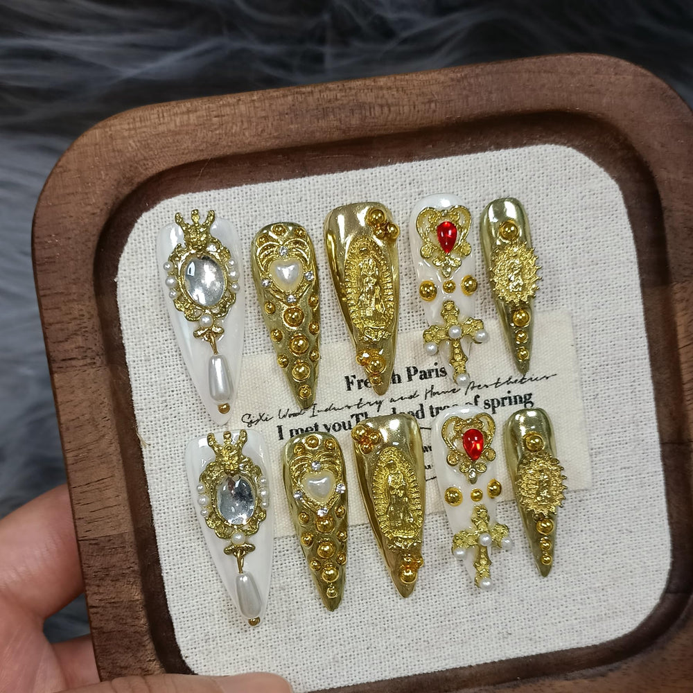 TENPAL royal press-on nails in metallic gold stiletto with pearls for a luxe look.