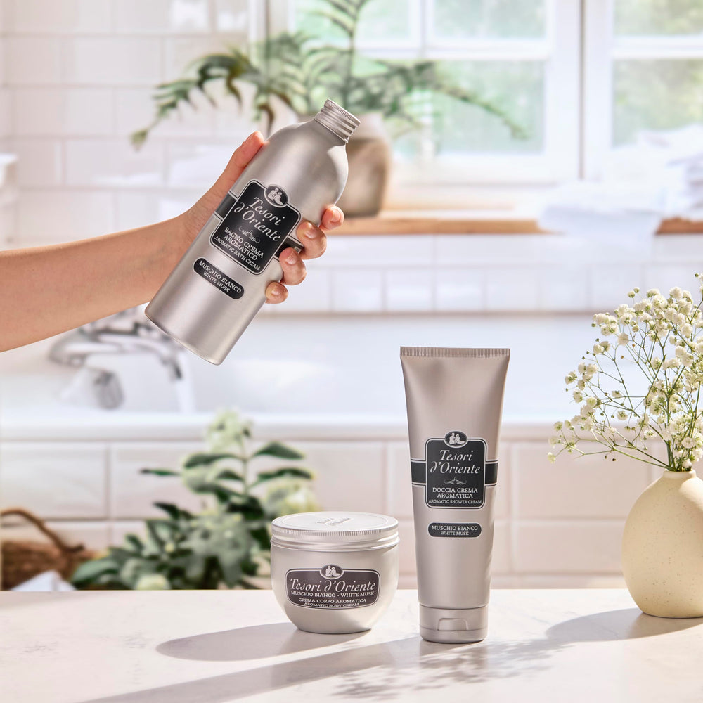 Applying Tesori d'Oriente body cream to skin for daily hydration.