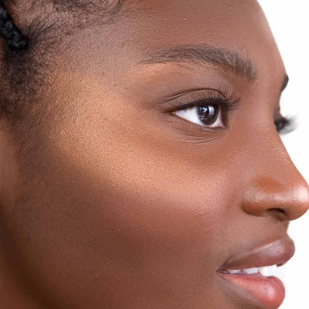 The Good Mineral Copper Gold highlighter applied with a brush for defined light.