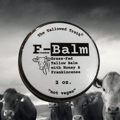 Two-ounce The Tallowed Truth balm beside skincare tools