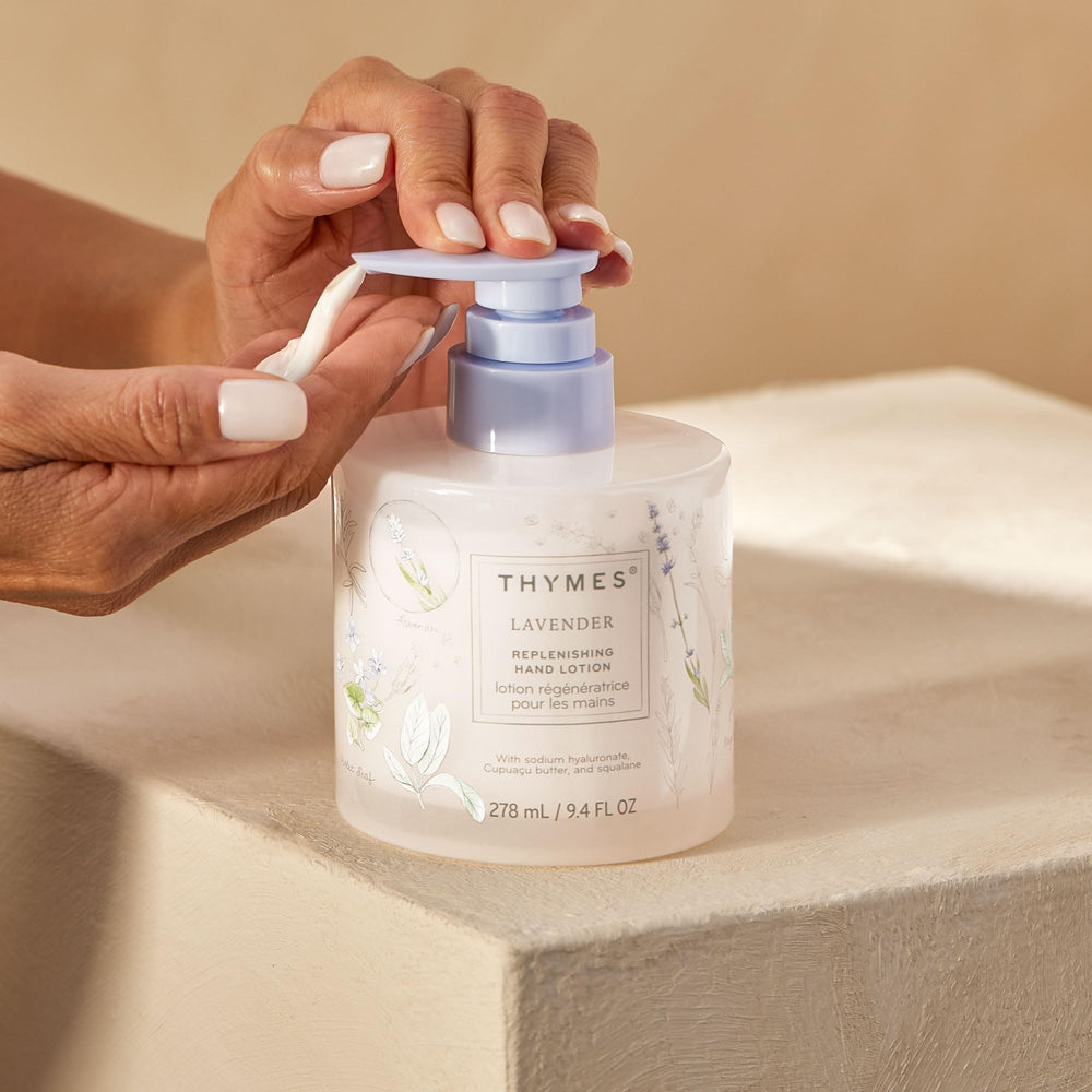 Thymes Replenishing Hand Lotion bottle on desk for daily self-care.
