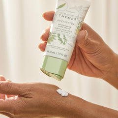 Travel-size Thymes Restorative Hand Cream tube displayed on desk