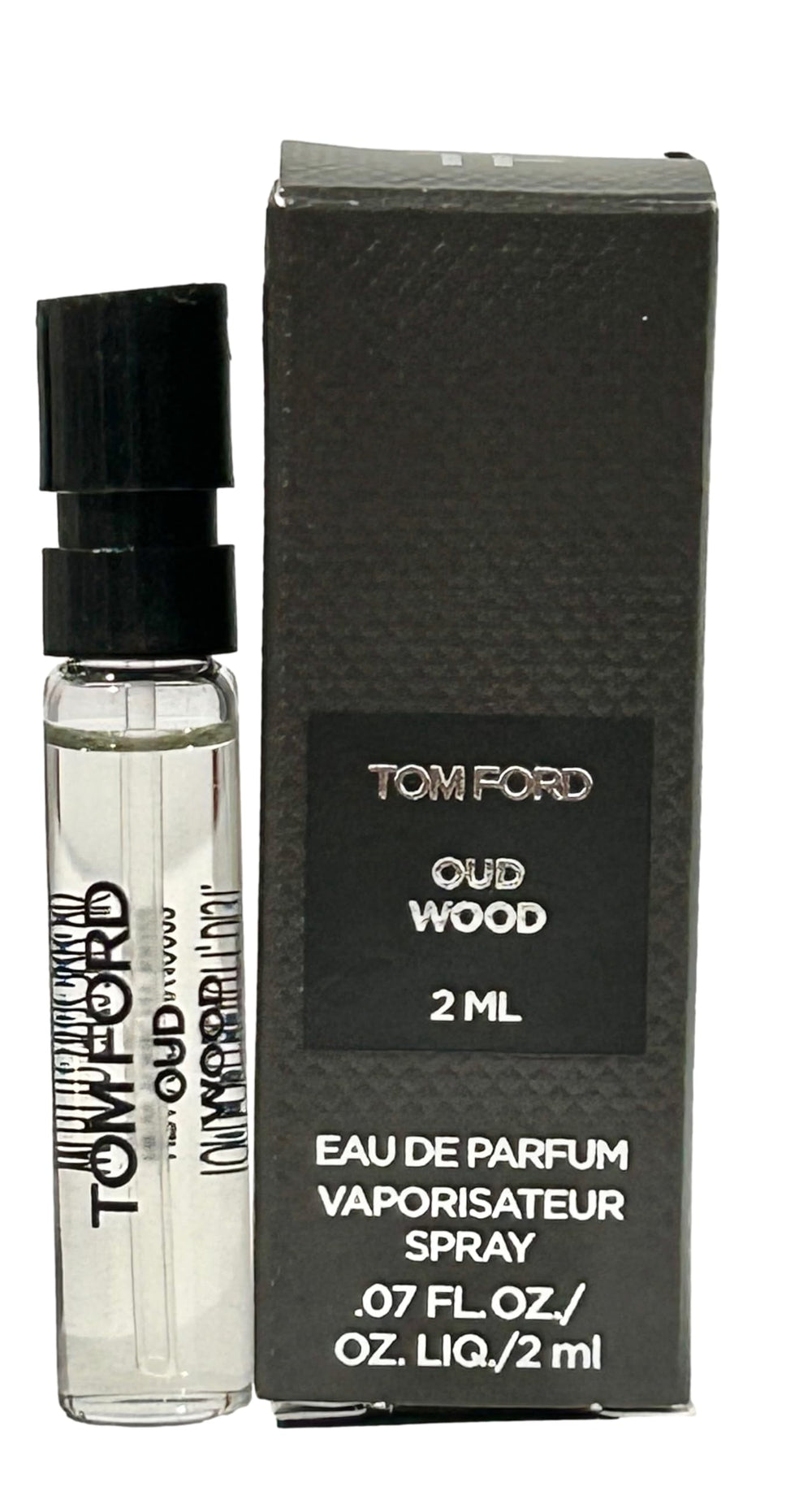 Tom Ford Oud Wood liquid close-up reveals rich amber tones.