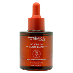 TOTEMICA Jojoba Oil Glow Elixir bottle close-up for hydration and radiance.