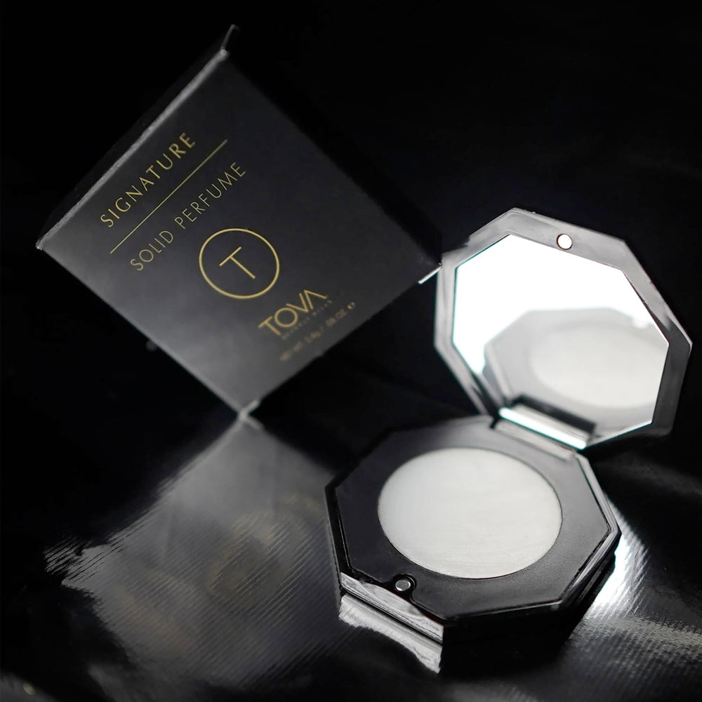 TOVA Signature Solid Perfume Compact applying dab for day-long freshness.