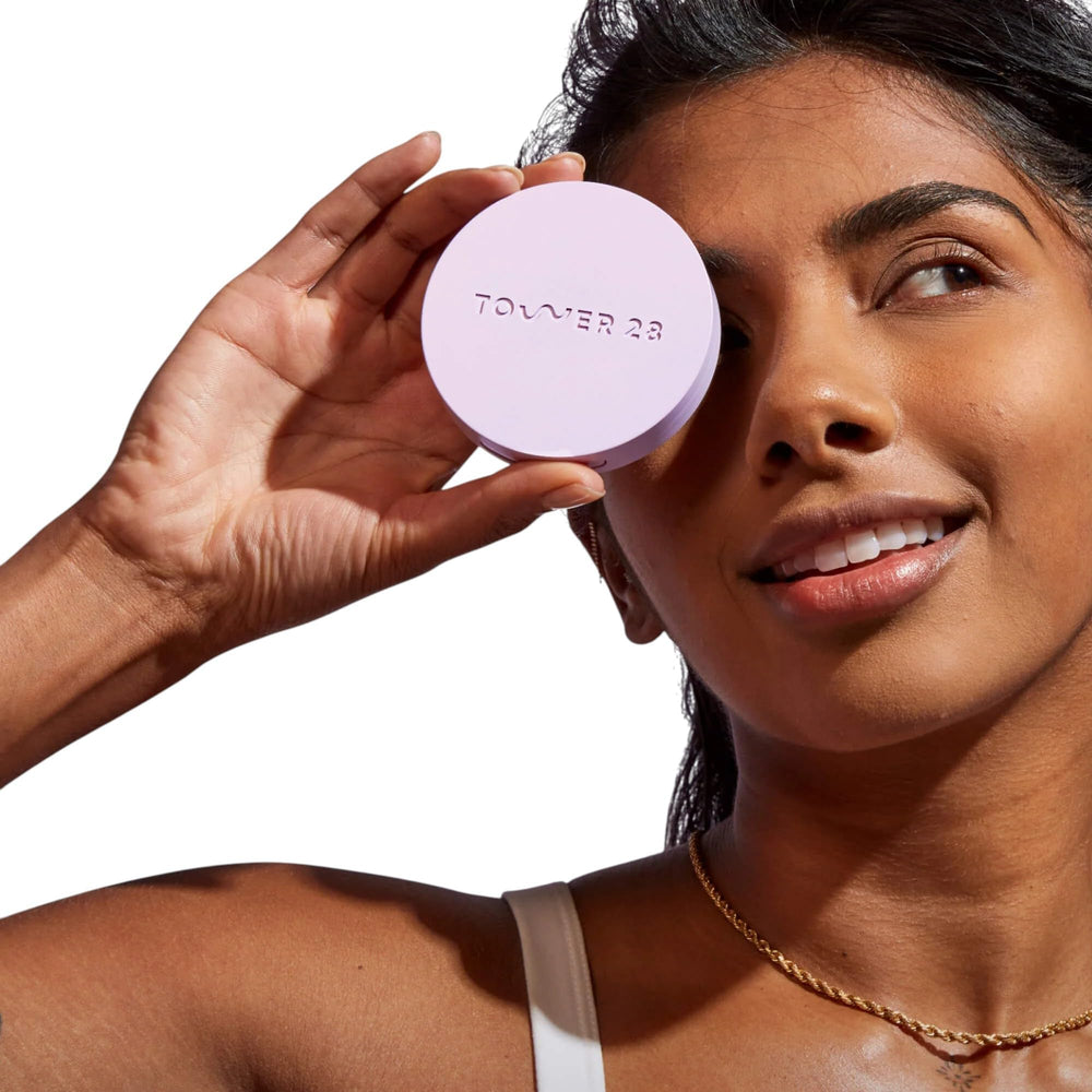 Close-up of Tower28 GetSet pink powder blurring pores for a soft matte look.