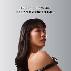 Applying TRUSS Deluxe Prime Mask to towel-dried hair for deep conditioning.