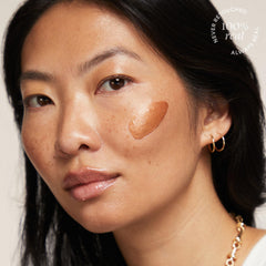 TULA Bronze Boost Glow applied to the face for seamless blending.