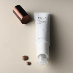 TULA Bronze Boost Glow packaging on a vanity setting.