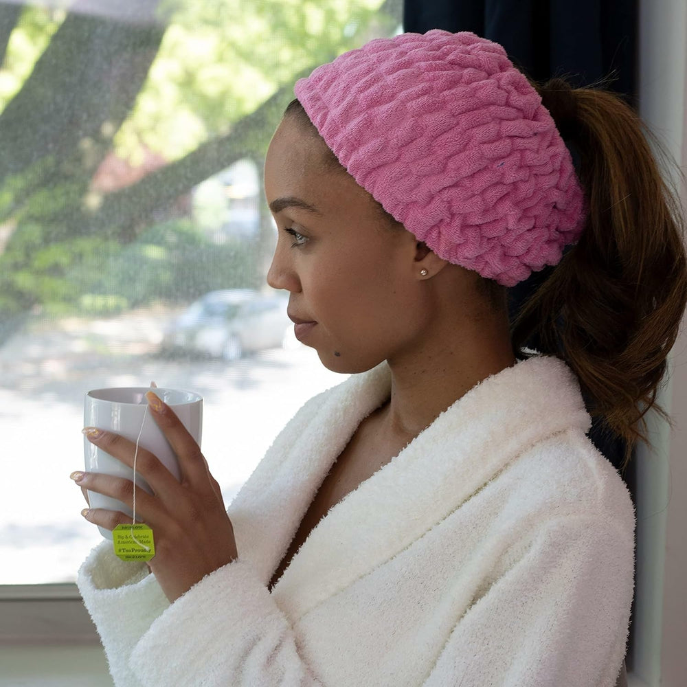 Turbie Twist extra-wide headband secures hair during routines.