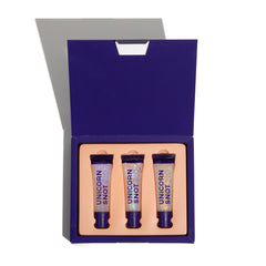 Unicorn Snot Glitter Boss lip gloss tube close-up emphasizing sparkly shine on lips.