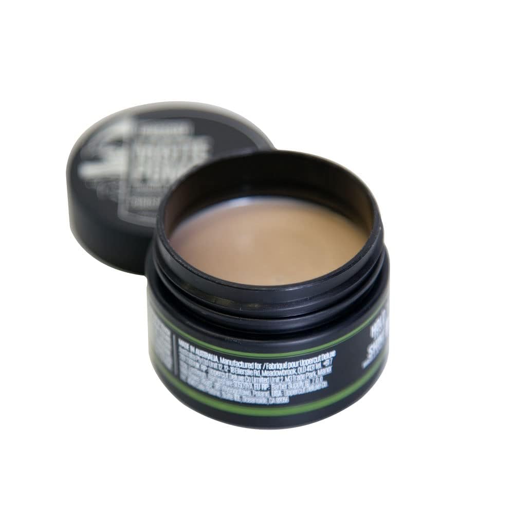 Uppercut Deluxe Matte Pomade MIDI compact pack on travel-ready bathroom shelf.