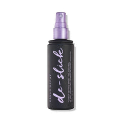 Urban Decay De-Slick bottle with matte spray for all-day oil control.