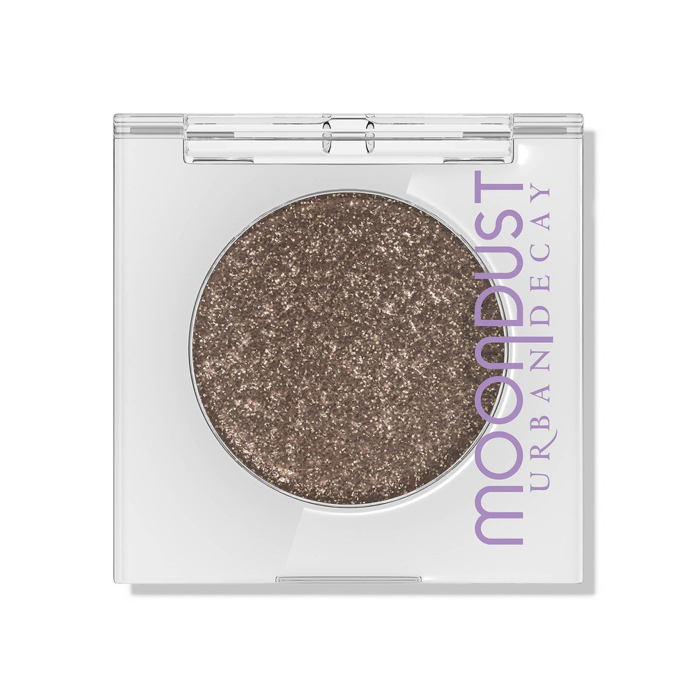 Urban Decay Moondust Space Cowboy glitter close-up showing long-wear champagne gold sparkle.