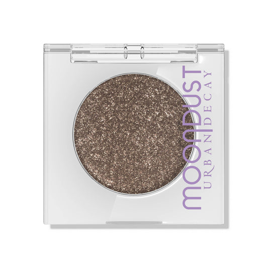 Urban Decay Moondust Space Cowboy glitter close-up showing long-wear champagne gold sparkle.