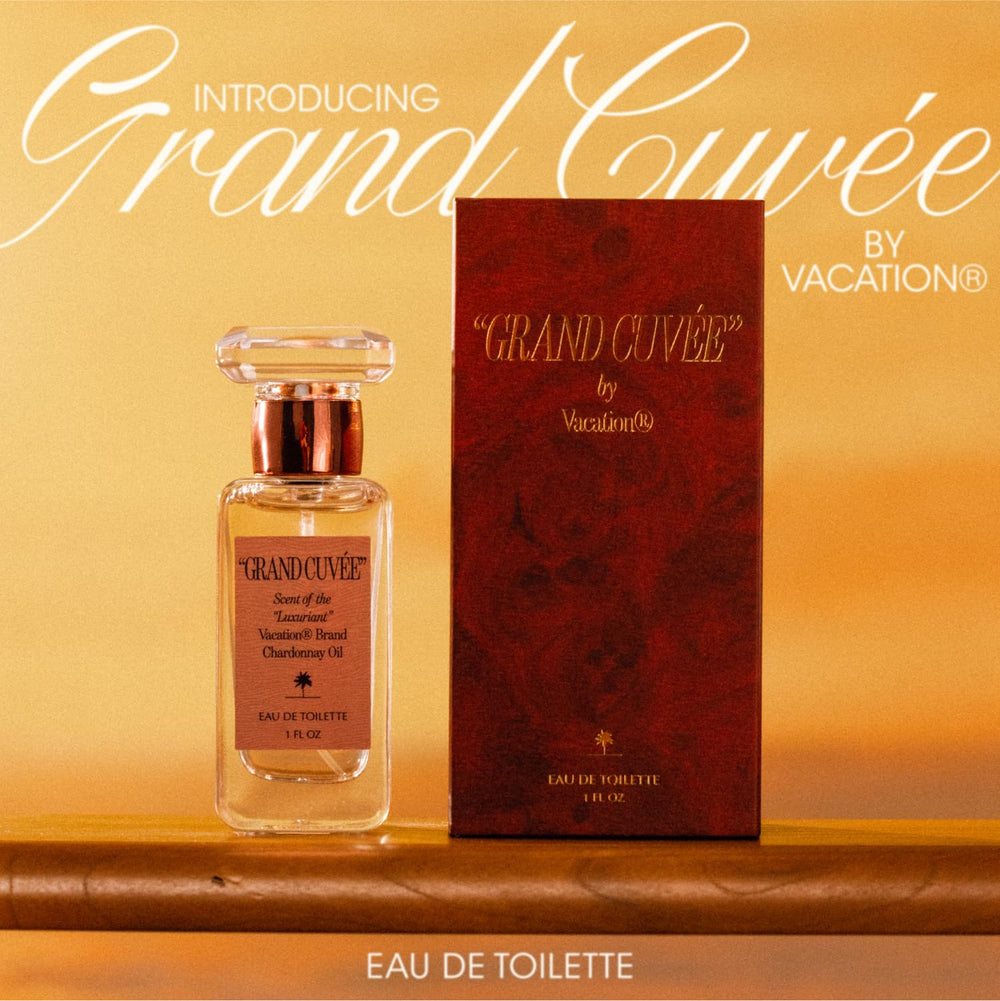VACATION Grand Cuve9e on a sunlit beach scene, travel-friendly fragrance in focus.