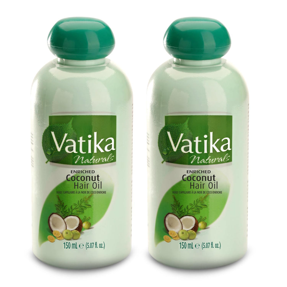Vatika Dabur coconut oil bottle pour for easy application and nourishment.