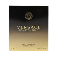 Versace Crystal Noir bottle on a reflective surface, ideal for evening wear.