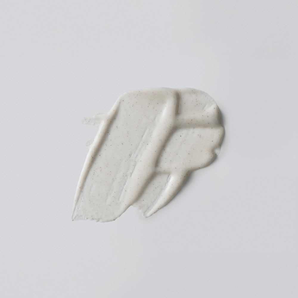 Versed Buff It Out texture close-up highlights microfine pumice for gentle exfoliation.