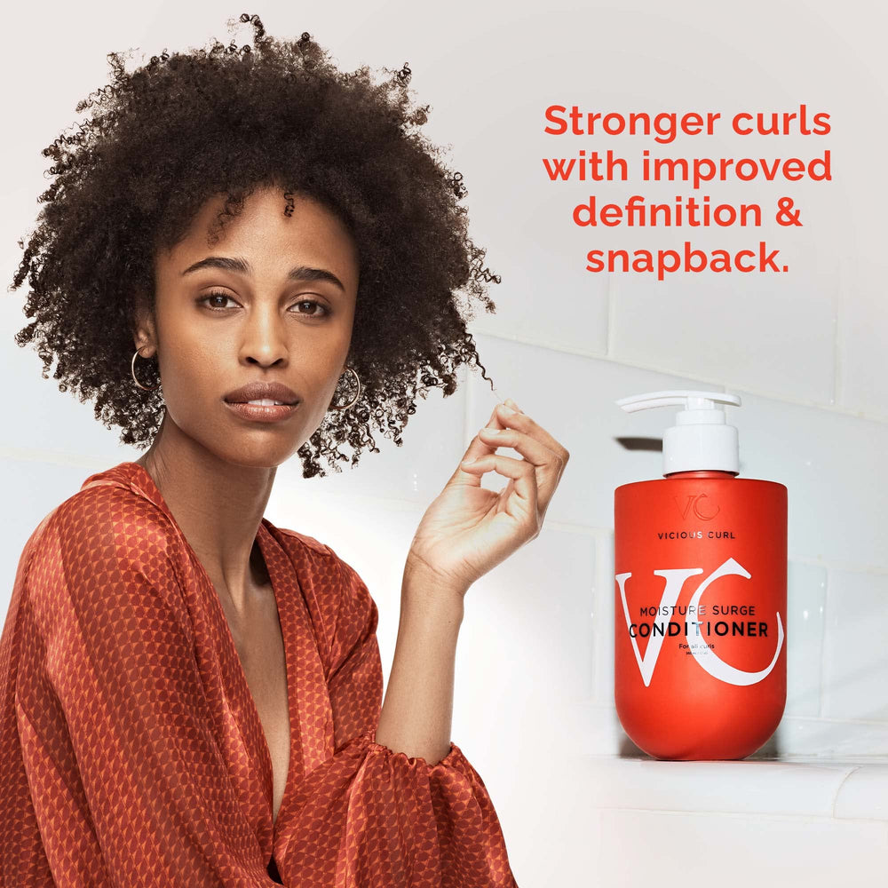 Model applies VICIOUS CURL Moisture Surge to mid-length hair for detangling.