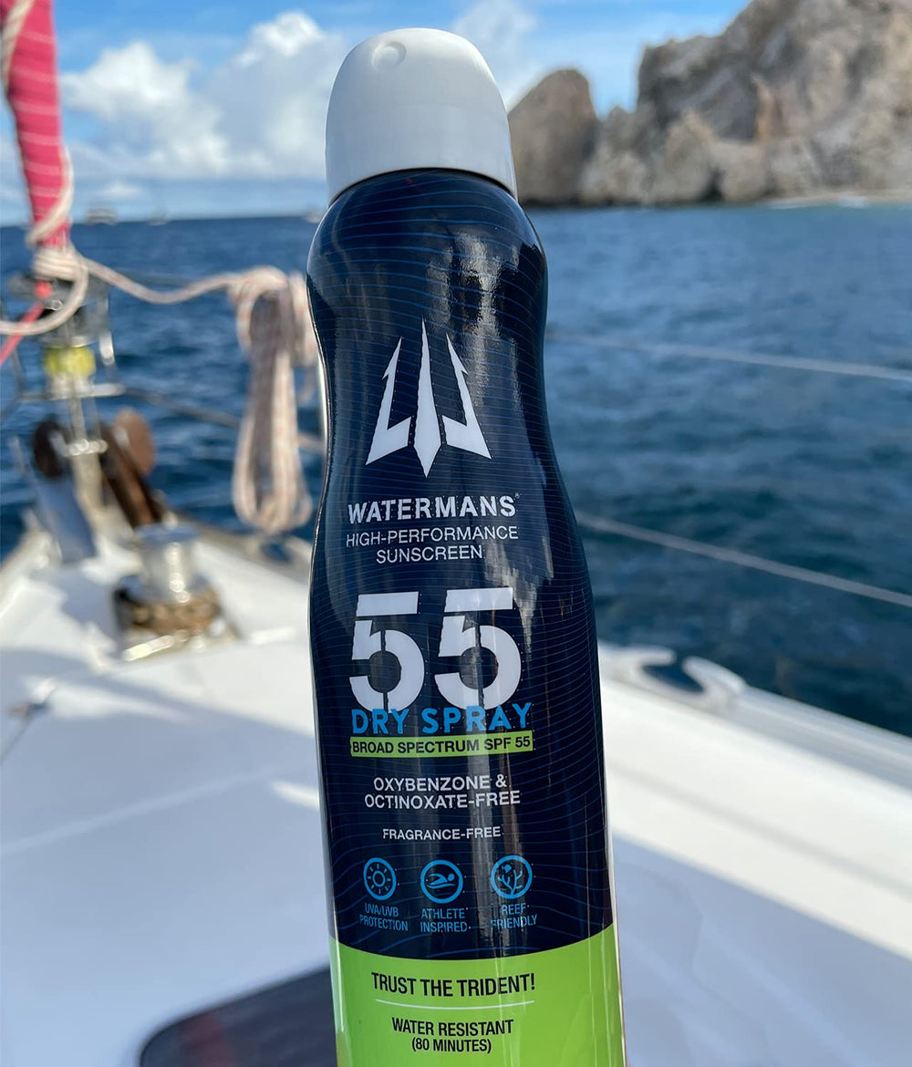 Watermans reef-safe SPF 55 being applied near water, highlighting eco-friendly protection.