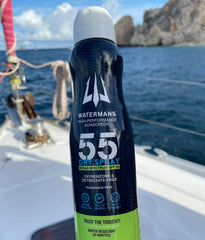 Watermans reef-safe SPF 55 being applied near water, highlighting eco-friendly protection.