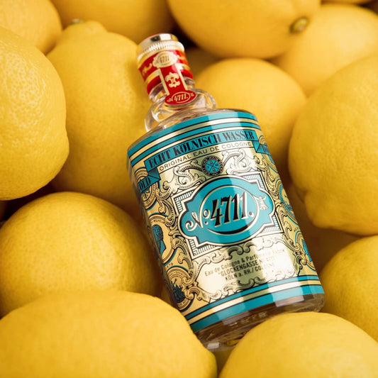 4711 Muelhens top-notes illustration highlighting orange oil, peach, bergamot and lemon scent notes.